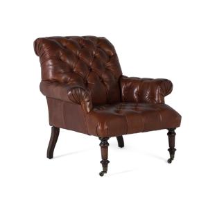 Sillón tapizado en cuero con reposabrazos acabado en capito…