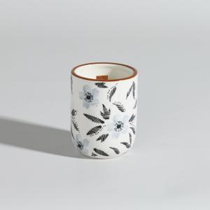 Vela perfumada en recipiente de cerámica beige, azul y negr…