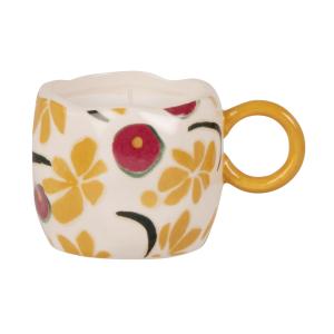 Vela perfumada en taza de dolomita con flores multicolor